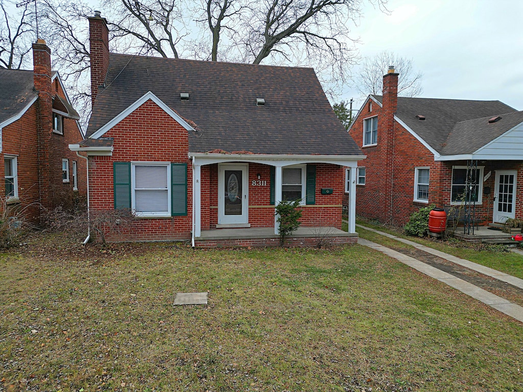 bungalow with a front lawn and covered porch