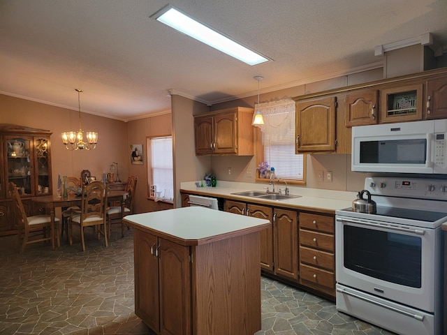 kitchen featuring pendant lighting, sink, white appliances, ornamental molding, and a kitchen island