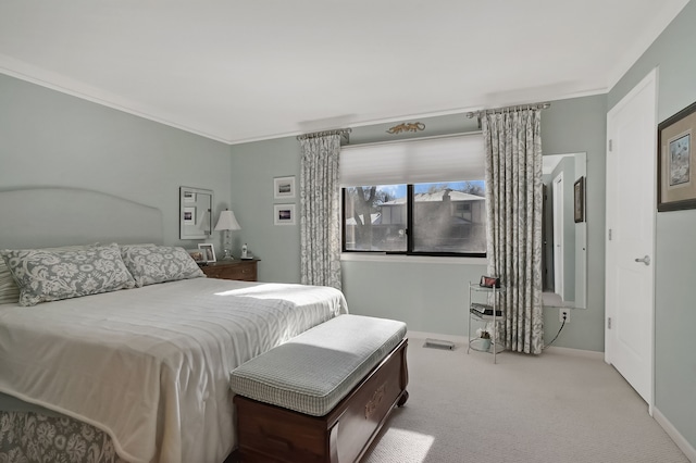 bedroom with baseboards, carpet flooring, and crown molding