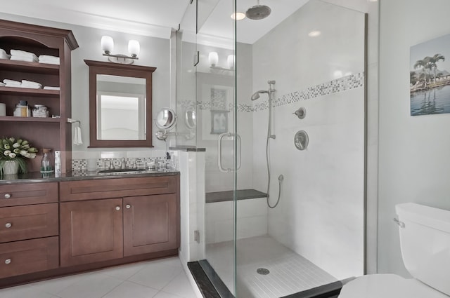 bathroom with vanity, a shower stall, toilet, and tile patterned floors