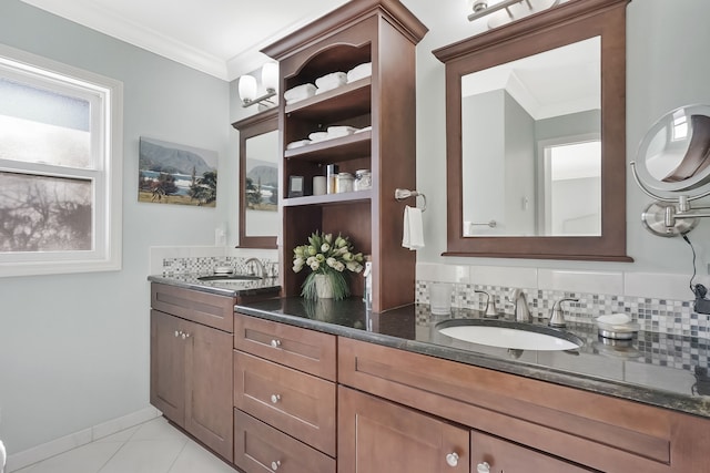 bathroom with crown molding, backsplash, and a sink