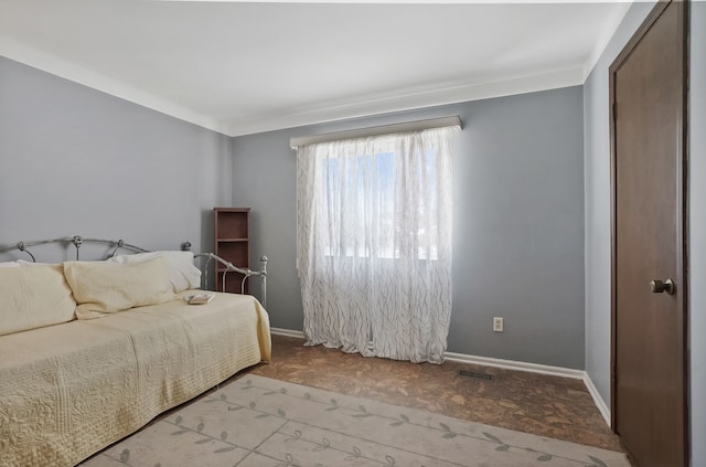 bedroom featuring visible vents and baseboards