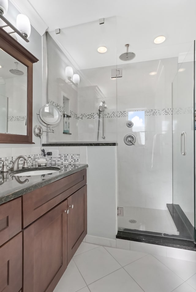 full bath featuring a shower stall, ornamental molding, tile patterned flooring, and vanity