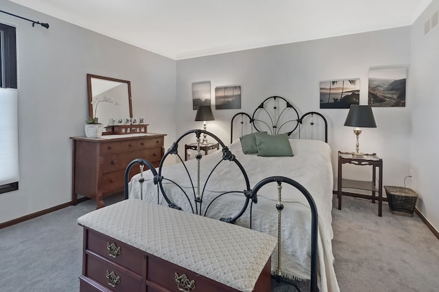 bedroom featuring carpet flooring, visible vents, and baseboards