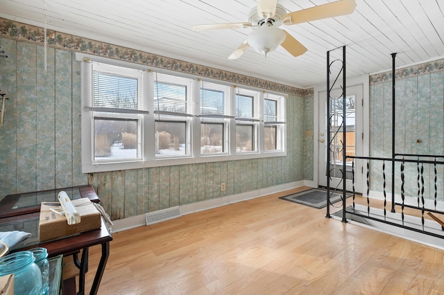 interior space with wood ceiling, light hardwood / wood-style flooring, and ceiling fan