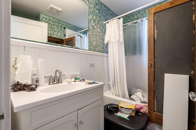 bathroom featuring shower / bath combo and vanity