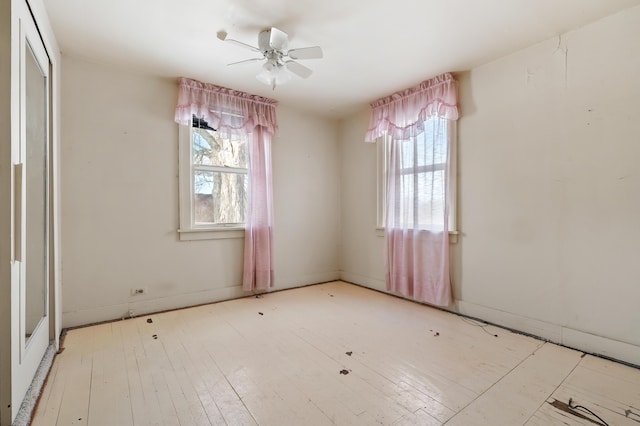 spare room with ceiling fan and light wood-type flooring