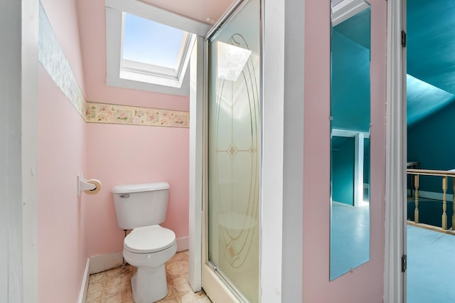 bathroom with toilet, a skylight, and a shower with door