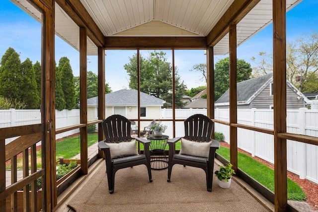 sunroom featuring vaulted ceiling