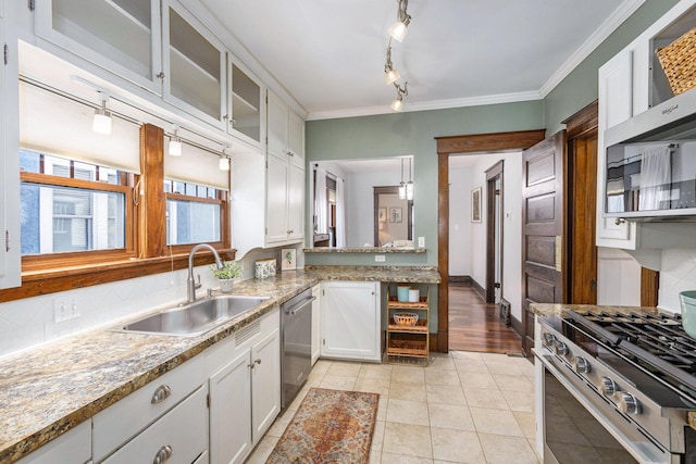 kitchen with sink, light tile patterned floors, white cabinets, and appliances with stainless steel finishes