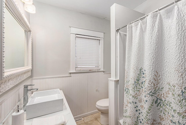 bathroom with vanity, tile patterned flooring, and toilet