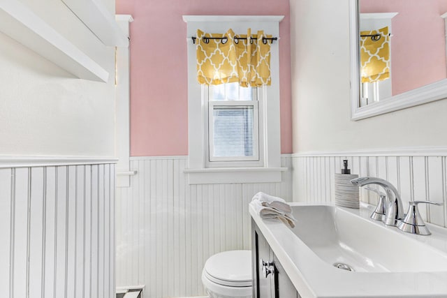 bathroom featuring vanity and toilet