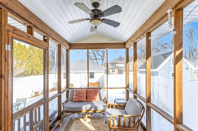 sunroom with lofted ceiling and ceiling fan