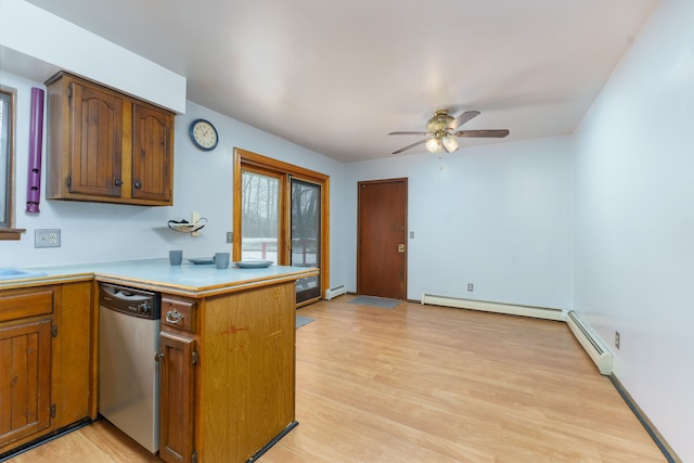 kitchen featuring a baseboard heating unit, light wood-type flooring, light countertops, and dishwasher