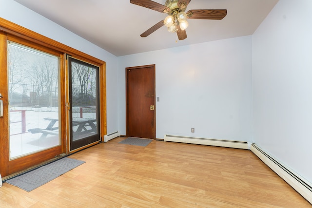 spare room featuring baseboard heating and a wealth of natural light