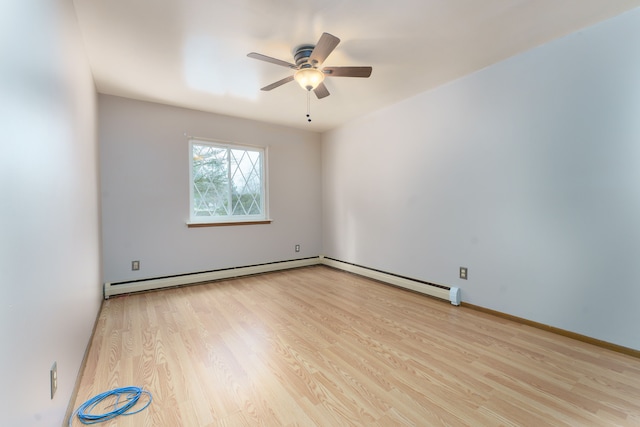 empty room featuring a ceiling fan, a baseboard radiator, baseboards, and wood finished floors