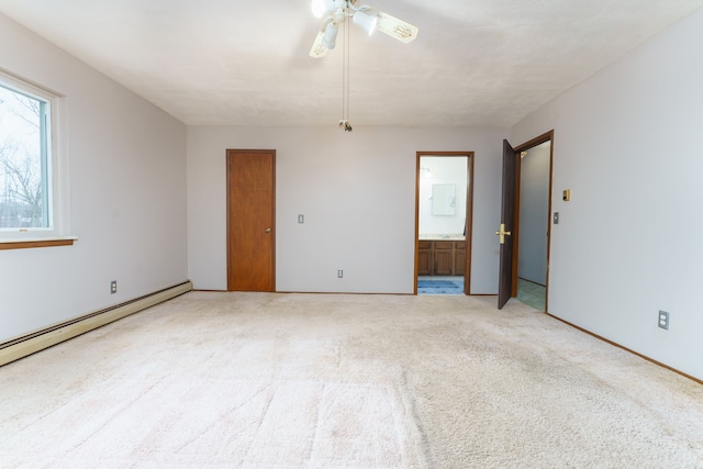 unfurnished room with ceiling fan, baseboard heating, and carpet