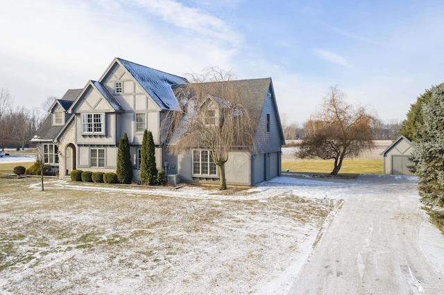 view of front of house featuring cooling unit and a garage