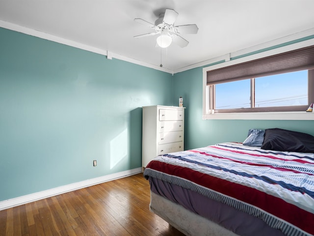 bedroom featuring crown molding, ceiling fan, and wood-type flooring