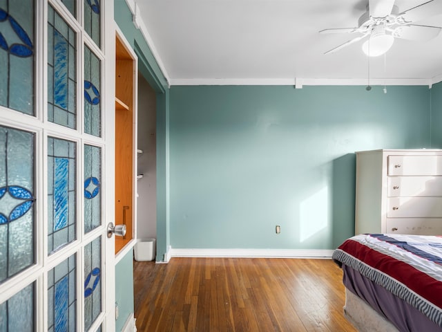 bedroom featuring crown molding, ceiling fan, and hardwood / wood-style floors