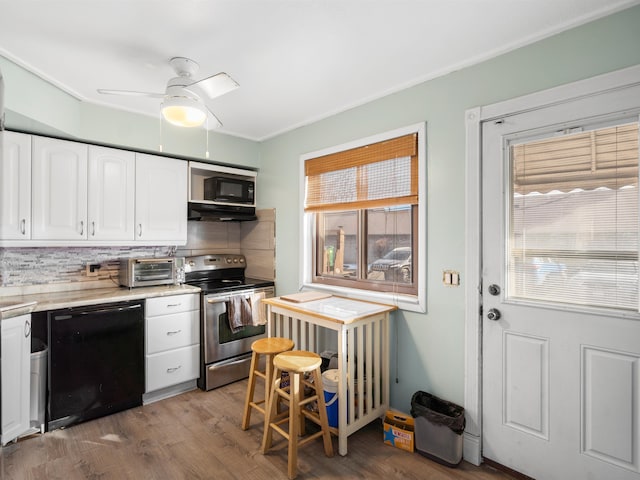 kitchen with tasteful backsplash, white cabinetry, ceiling fan, black appliances, and dark wood-type flooring