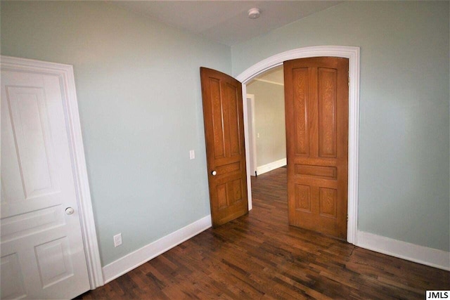 spare room with dark hardwood / wood-style flooring