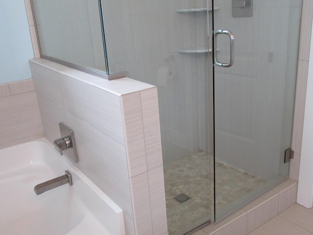 full bath with a garden tub and a shower stall