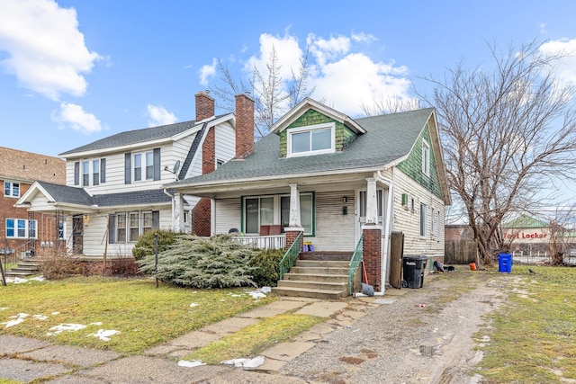 view of front of house with a porch and a front lawn