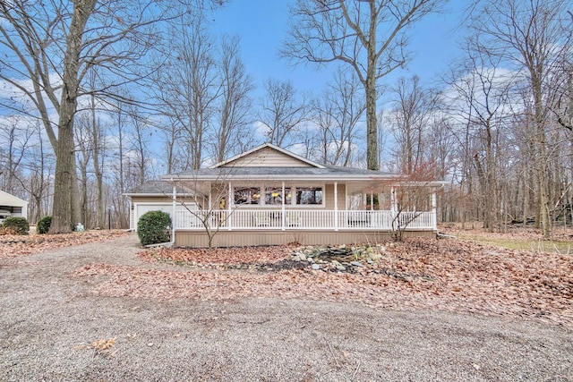 farmhouse featuring a garage and covered porch