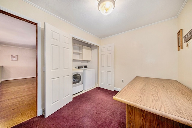 washroom with separate washer and dryer, dark carpet, crown molding, and cabinets