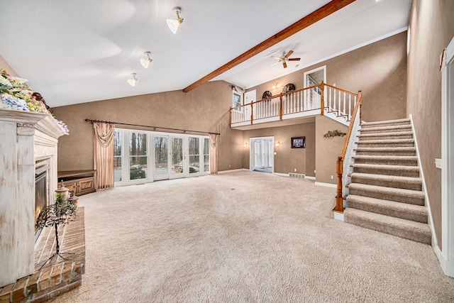 unfurnished living room featuring beam ceiling, carpet floors, high vaulted ceiling, and ceiling fan