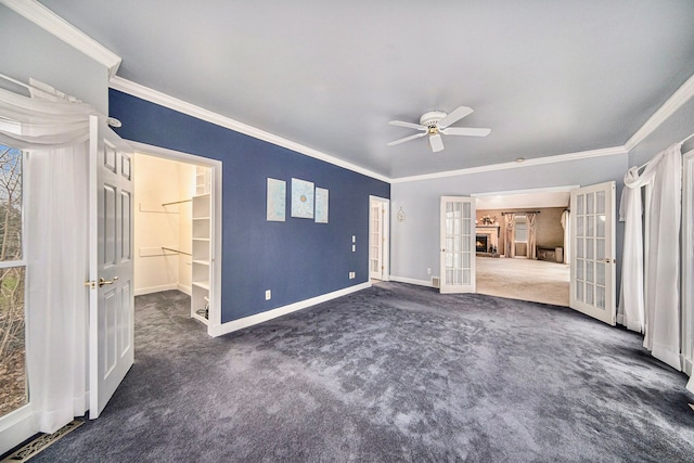 unfurnished bedroom featuring french doors, ceiling fan, ornamental molding, and dark colored carpet