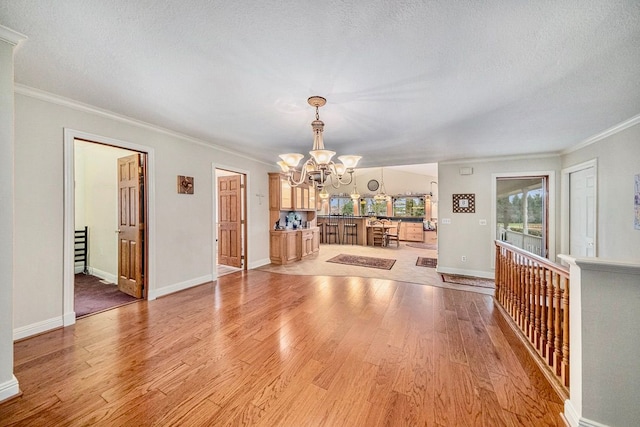 interior space with a textured ceiling, light hardwood / wood-style flooring, and a chandelier