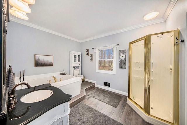 bathroom with crown molding, vanity, plus walk in shower, and hardwood / wood-style floors