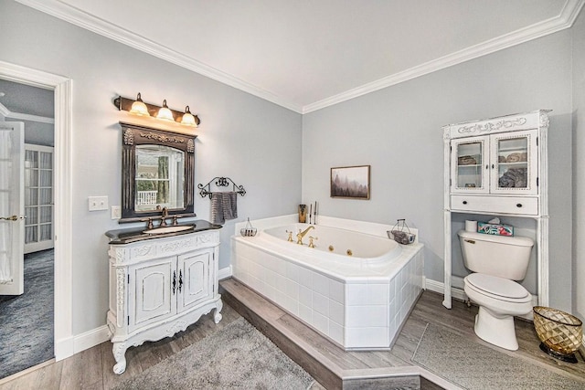 bathroom with a relaxing tiled tub, hardwood / wood-style floors, crown molding, and vanity