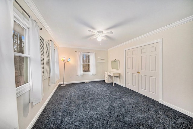 unfurnished bedroom with crown molding, ceiling fan, and dark carpet