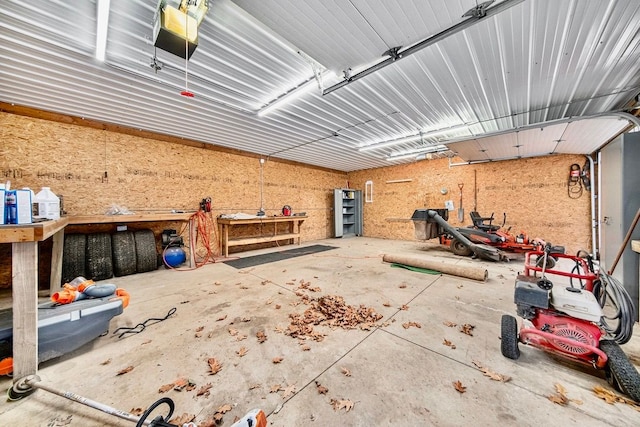 garage with a garage door opener and a workshop area