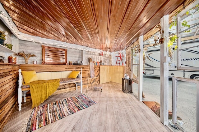 living area featuring hardwood / wood-style floors and wood ceiling