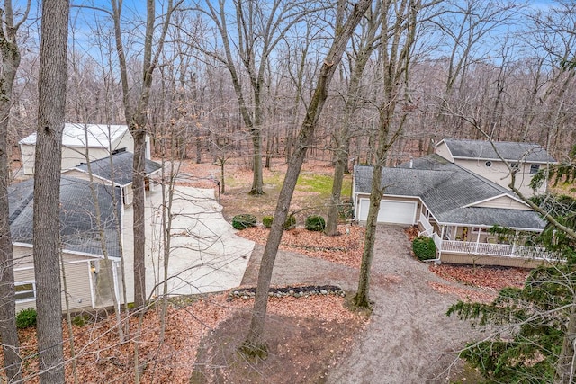 view of yard featuring a garage and a porch