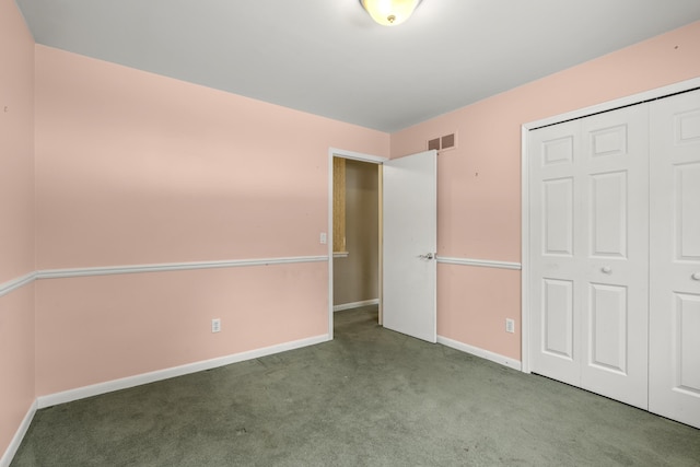 unfurnished bedroom featuring light colored carpet and a closet