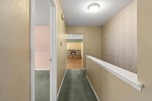 hallway featuring dark colored carpet