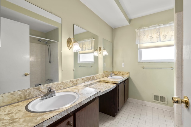 bathroom featuring walk in shower, tile patterned floors, and vanity