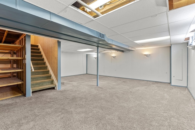 basement with carpet floors and a drop ceiling