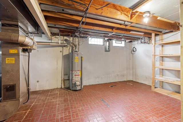 basement with electric panel, heating unit, and gas water heater