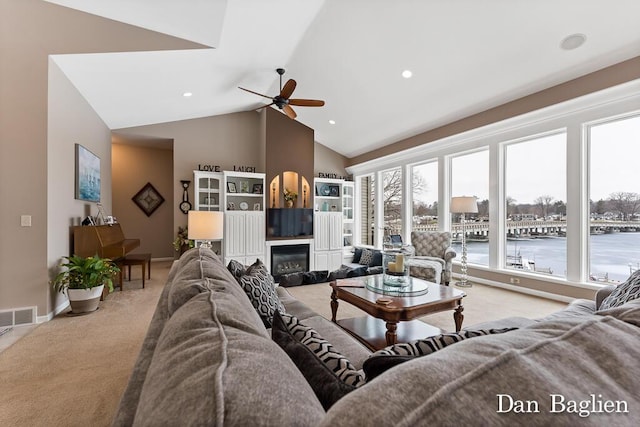 carpeted living room with lofted ceiling and ceiling fan