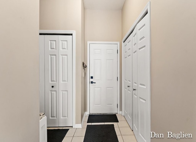 entryway with light tile patterned flooring