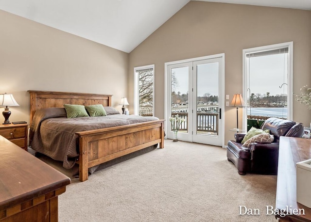 carpeted bedroom with a water view, lofted ceiling, and access to exterior