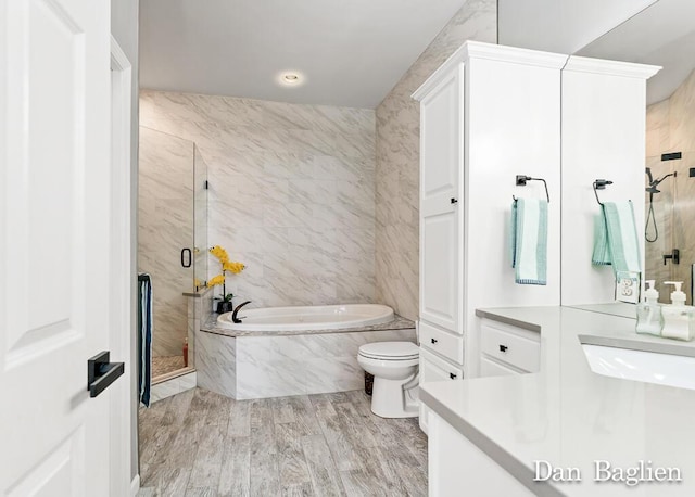 full bathroom featuring vanity, hardwood / wood-style floors, independent shower and bath, and toilet