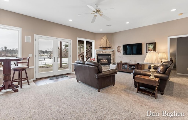 carpeted living room with french doors and ceiling fan