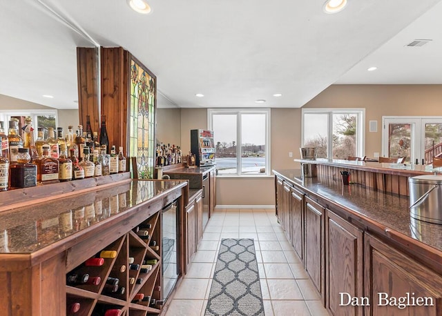 bar featuring light tile patterned floors and wine cooler